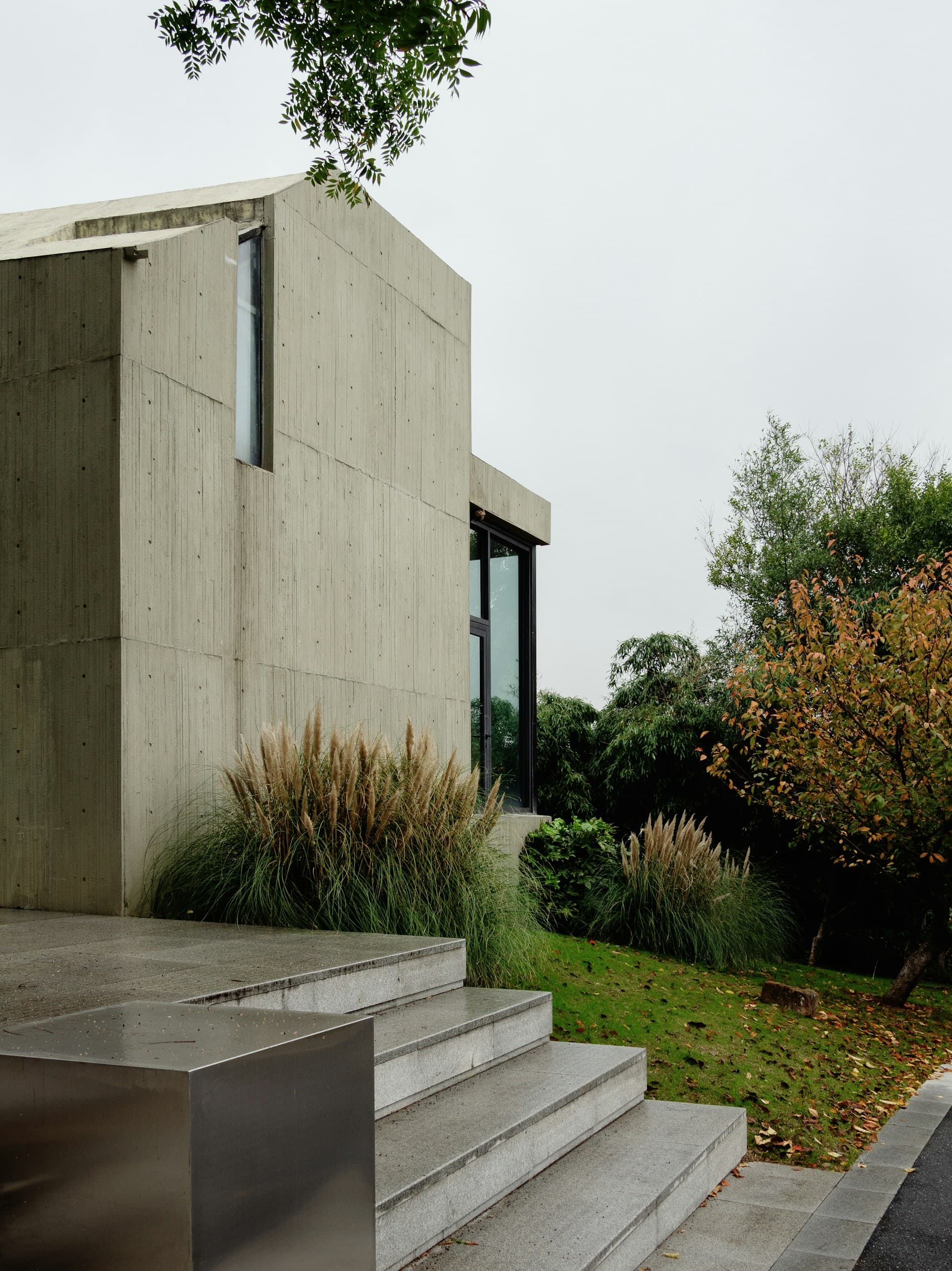 Limestone House - A monolithic exterior, softened by light and planting.